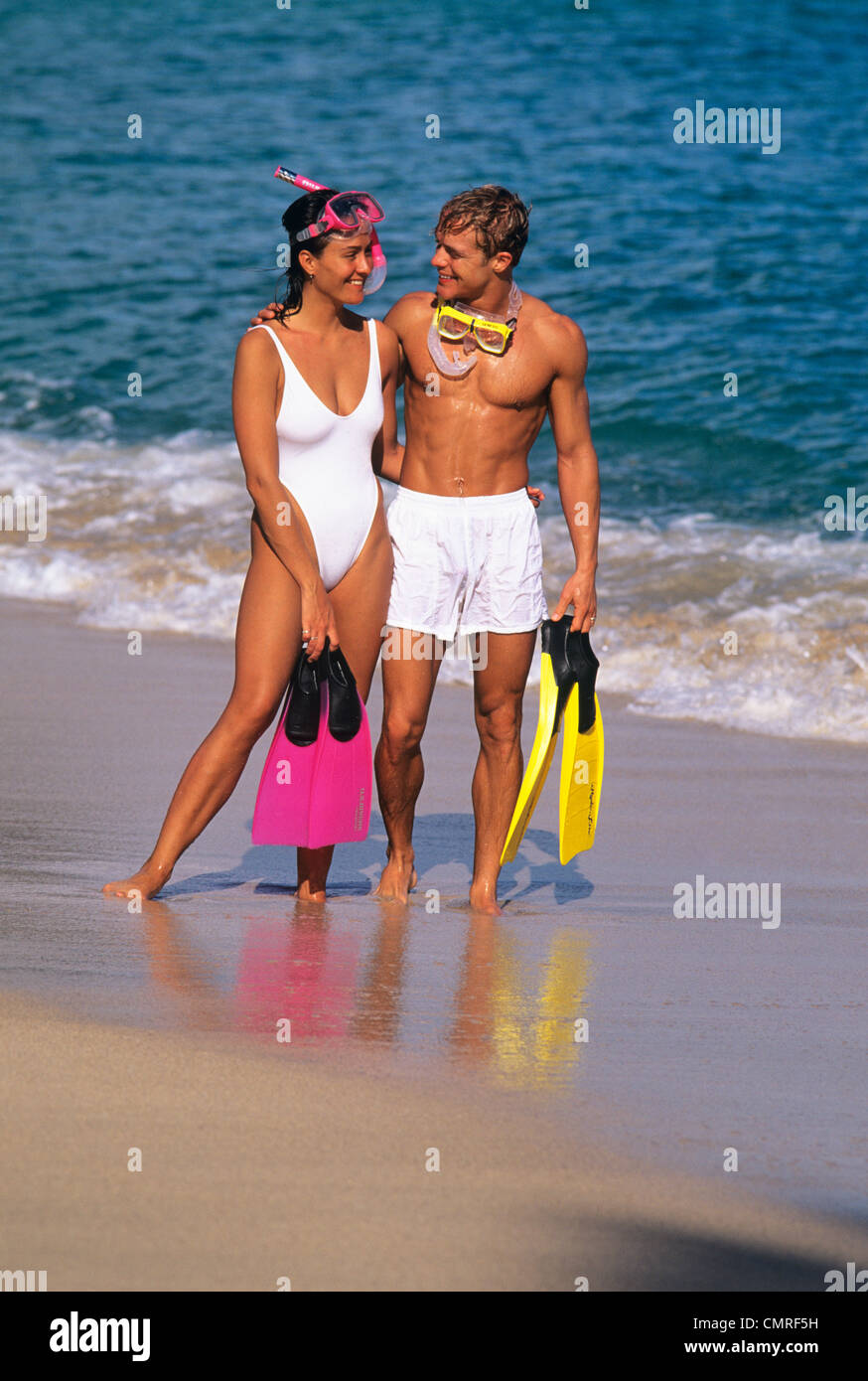 1990ER JAHREN PAAR MIT SCHNORCHELN AUSRÜSTUNG AM STRAND Stockfoto