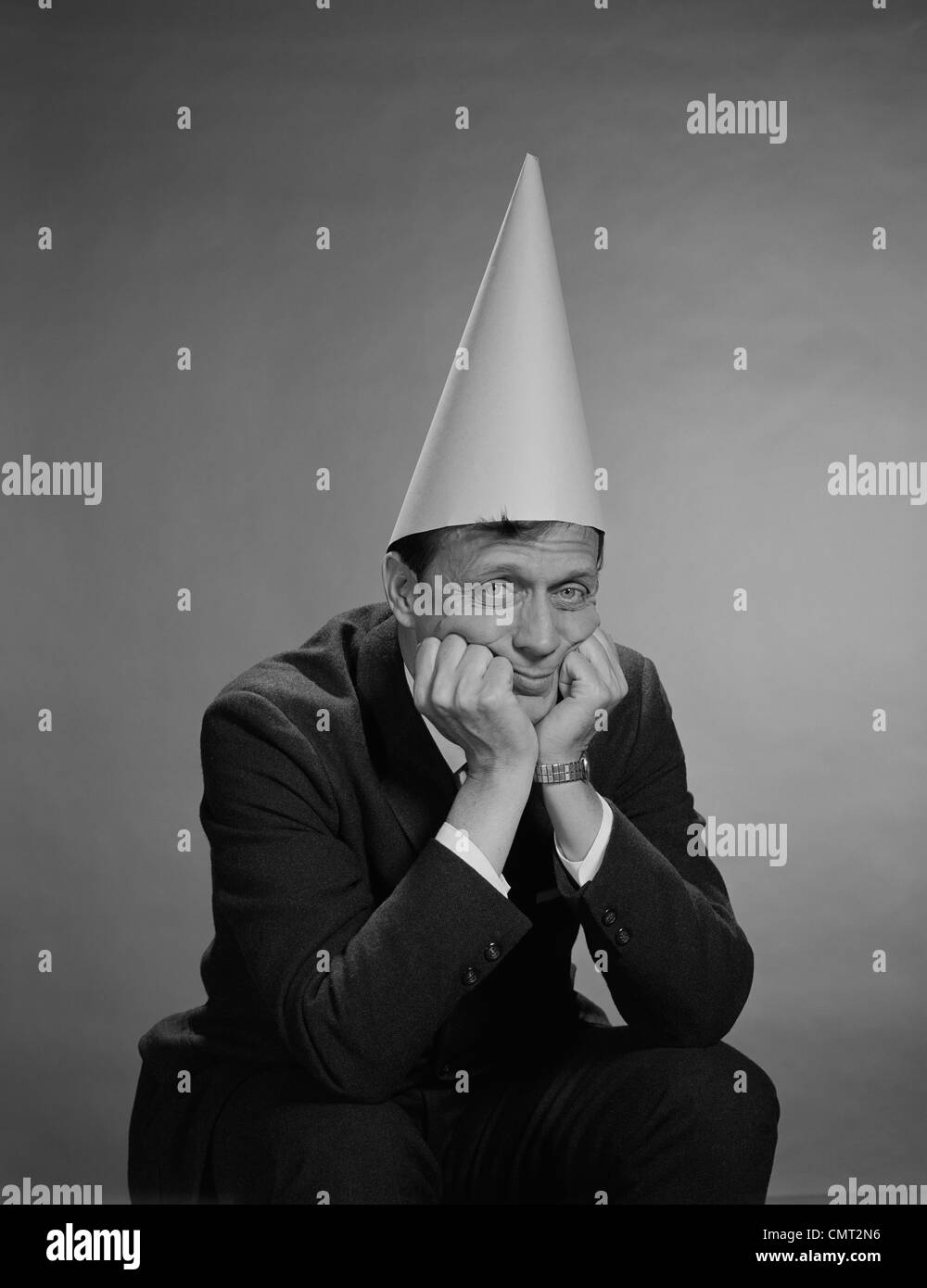 1960ER JAHRE MANN MIT DUNCE MÜTZE Stockfoto