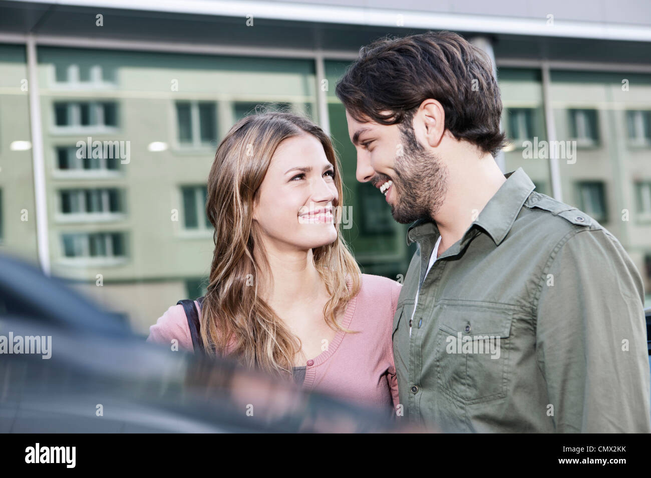 Deutschland, Köln, junges Paar in der Nähe von Auto, Lächeln Stockfoto