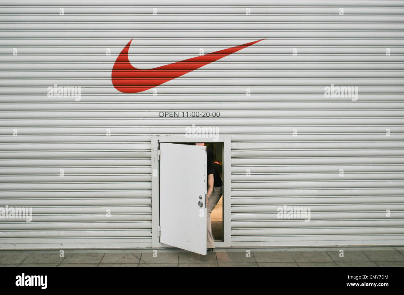 Nike-swoosh gemalt auf einem Nike Store Fensterläden in Hiroshima, Japan. Stockfoto