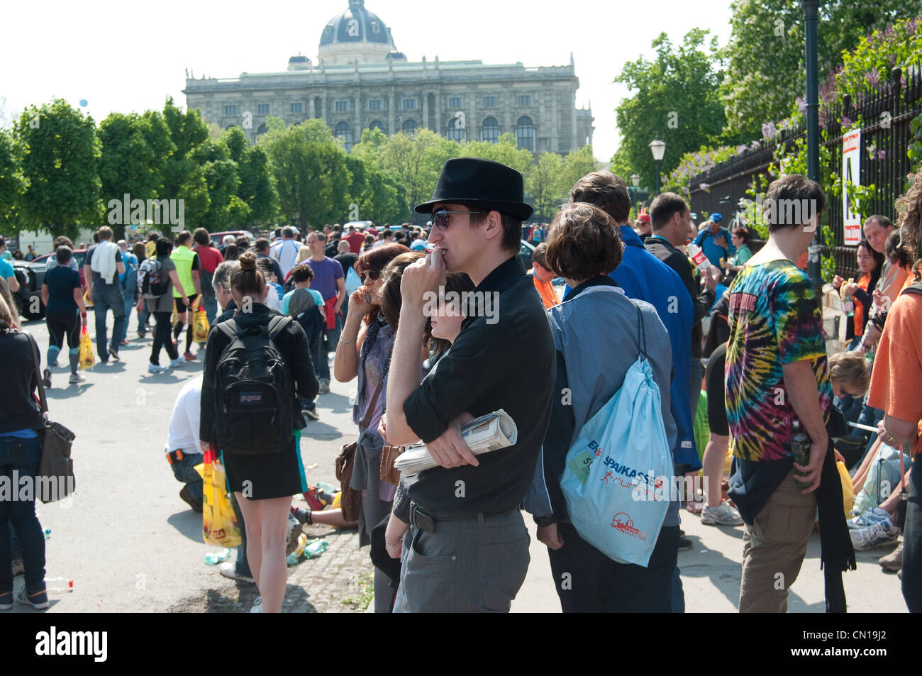 Der Mensch steht in einer Menschenmenge einen schwarzen Hut nach dem Vienna City Marathon Stockfoto