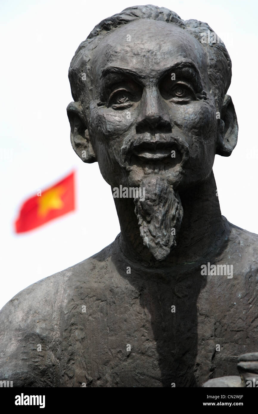 Statue von Ho Chi Minh mit vietnamesischen Flagge im Hintergrund Stockfoto