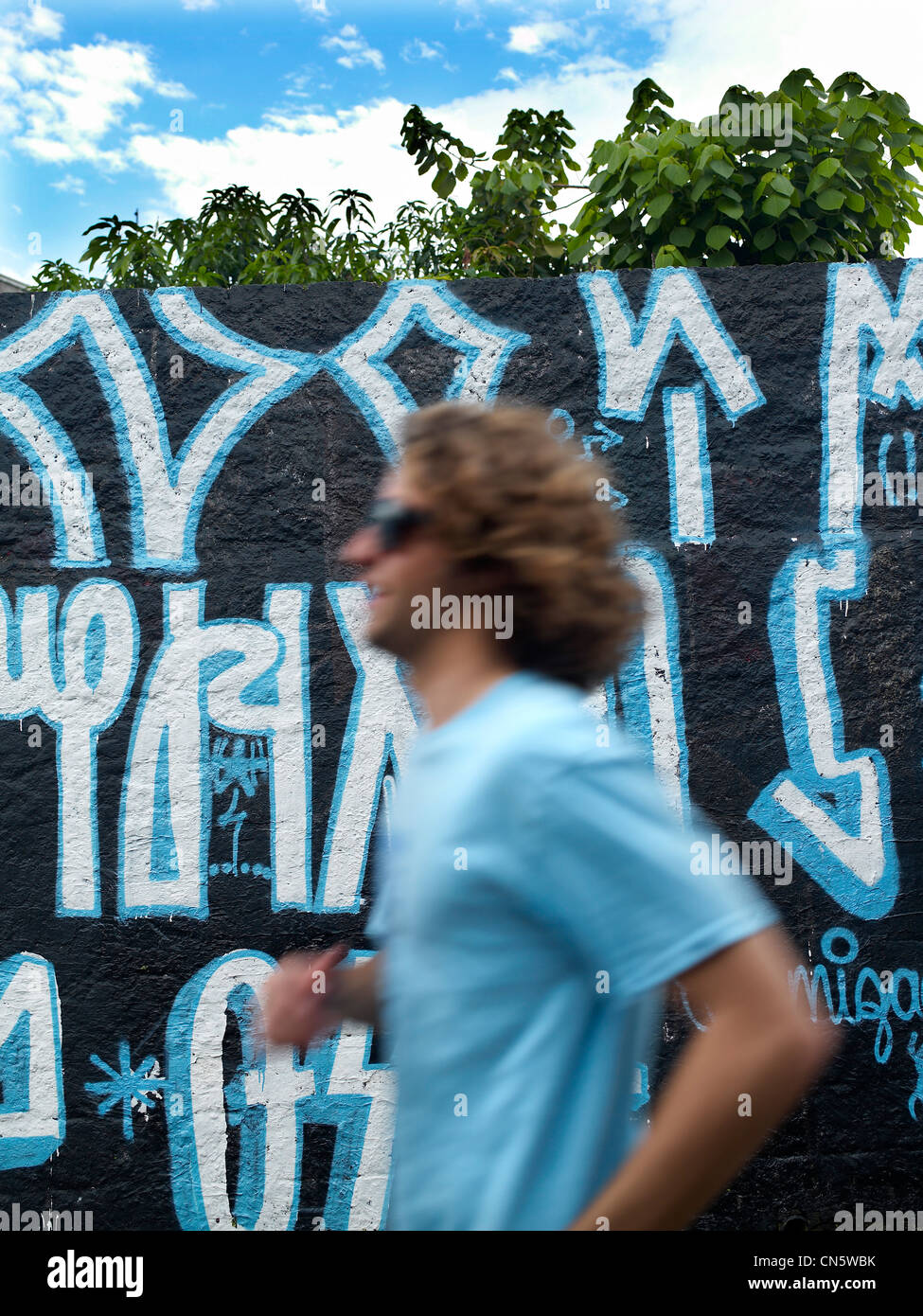 Brasilien, Sao Paulo, feature: São Paulo vertraulich, Jogger vor einer tagged Wand Stockfoto