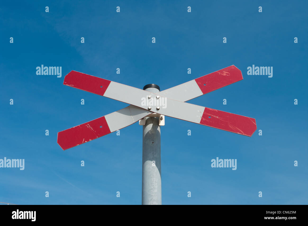 rot mit weißen Eisenbahn Straßenschild vor blauem Himmel Stockfoto