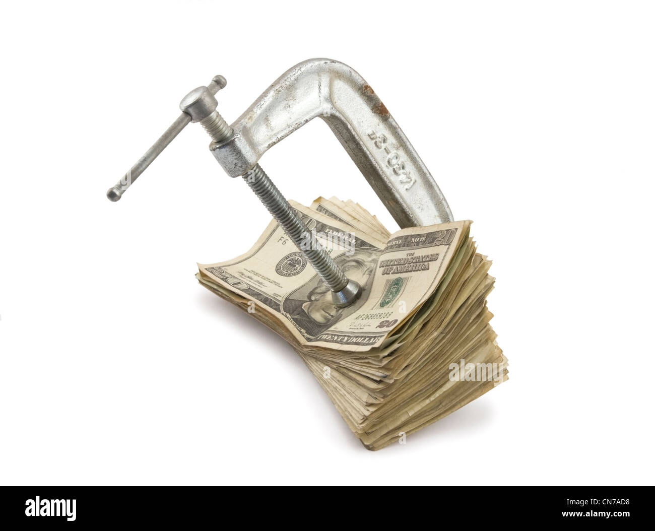 C-Clamp setzen Druck auf amerikanisches Geld. Stockfoto