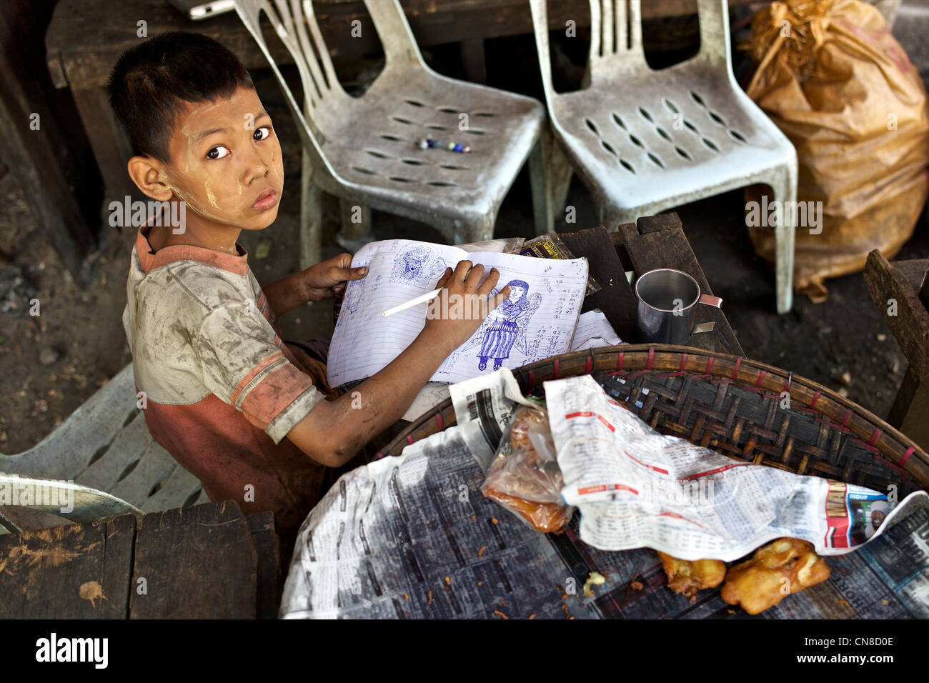 Ein Junge Burmesische stützt sich auf einer Straße in Rangoon, Birma Stockfoto