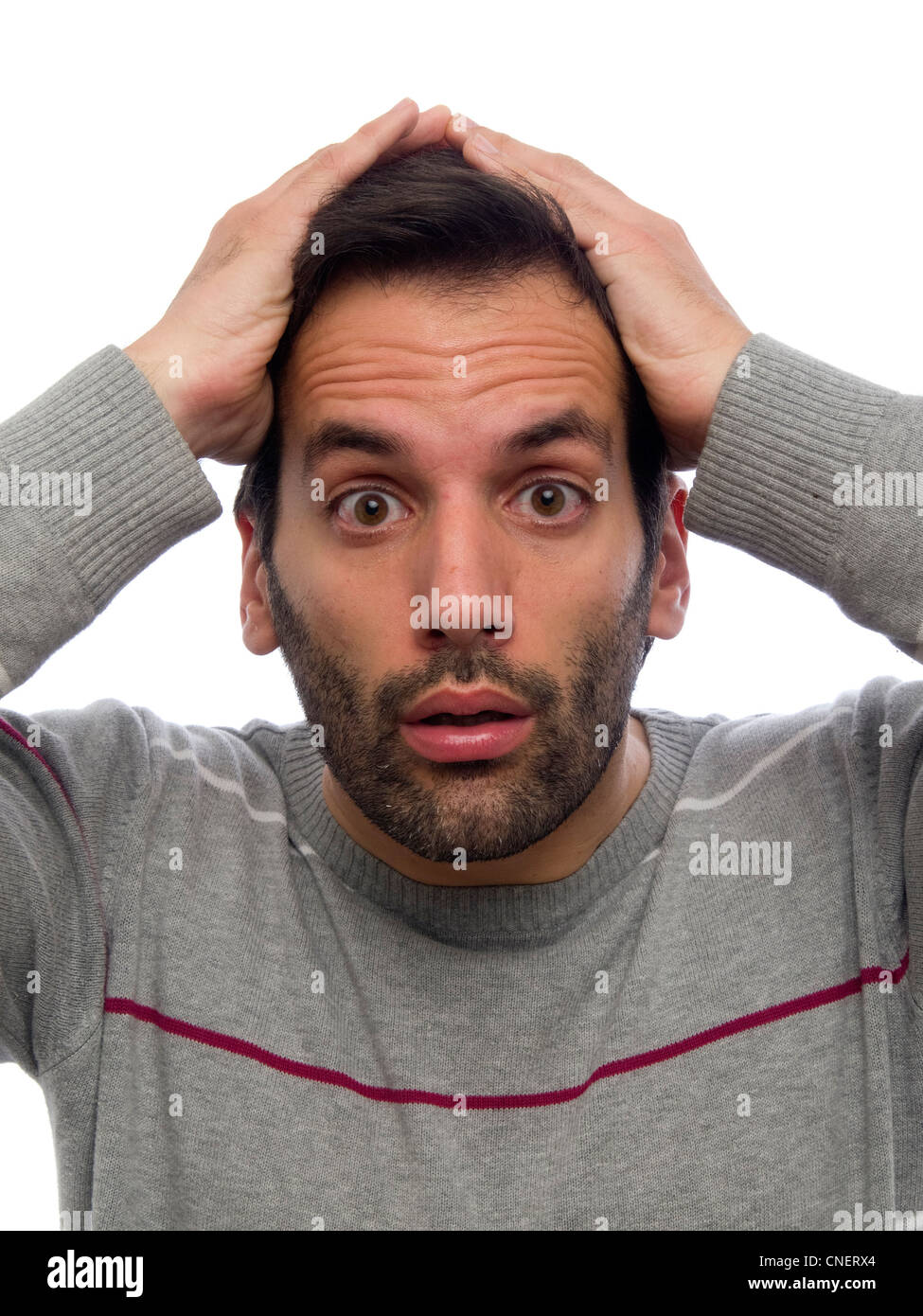 Porträt eines jungen Mannes mit Bart, Blick in die Kamera mit überrascht die Hände auf den Kopf Stockfoto