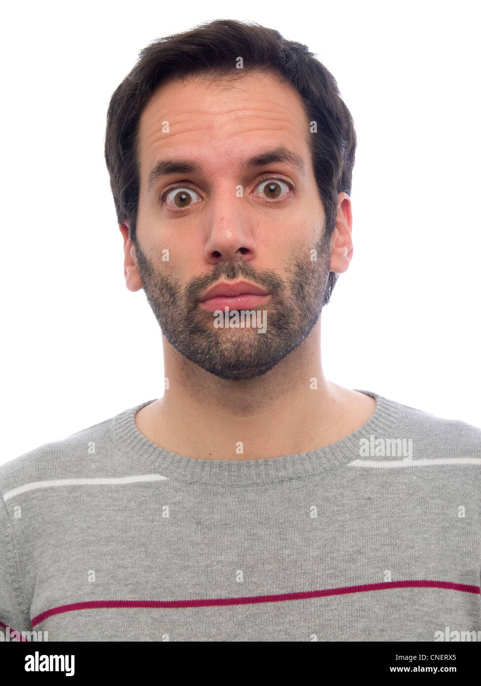 Porträt eines jungen Mannes mit Bart, Blick in die Kamera überrascht Stockfoto