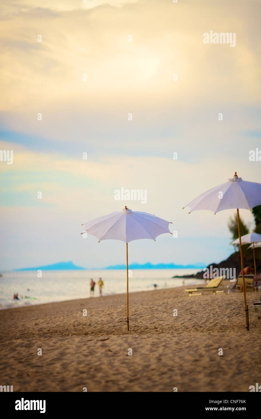 Sonnenschirme am Strand am Abend in Thailand Stockfoto