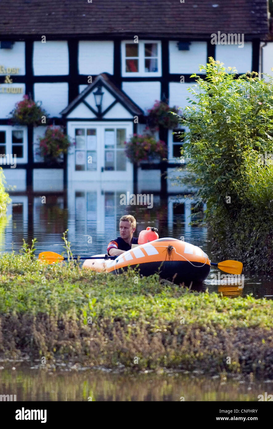 Ein Opfer der Flut macht seinen Weg in Richtung der überfluteten Rose &amp; Crown Pub am Severn Stoke in der Nähe von Malvern. Stockfoto