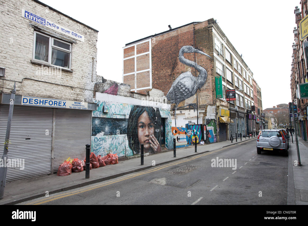 Graffiti bedeckt Gebäuden rund um Brick Lane in East London, UK Stockfoto