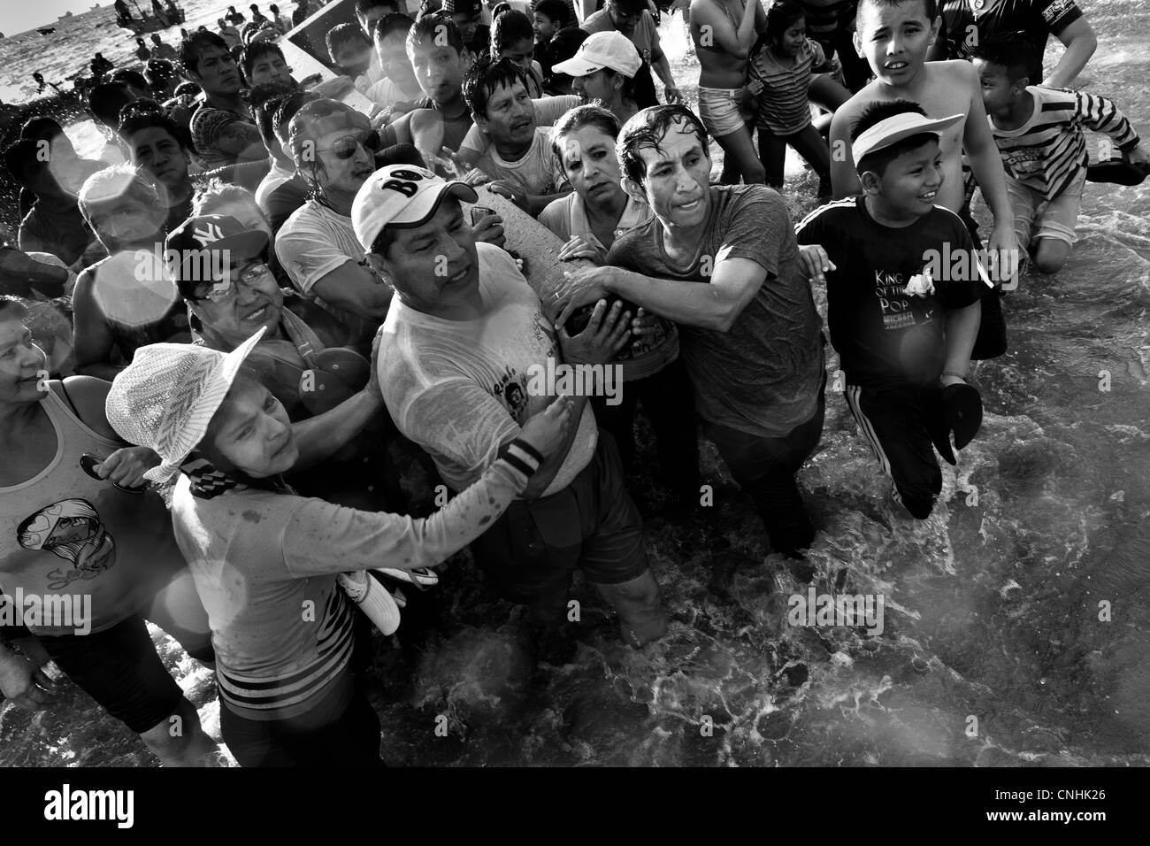 Katholischen Anhänger tragen das Holzkreuz im Meer während des jährlichen Rituals der Karwoche in Santa Elena, Ecuador. Stockfoto