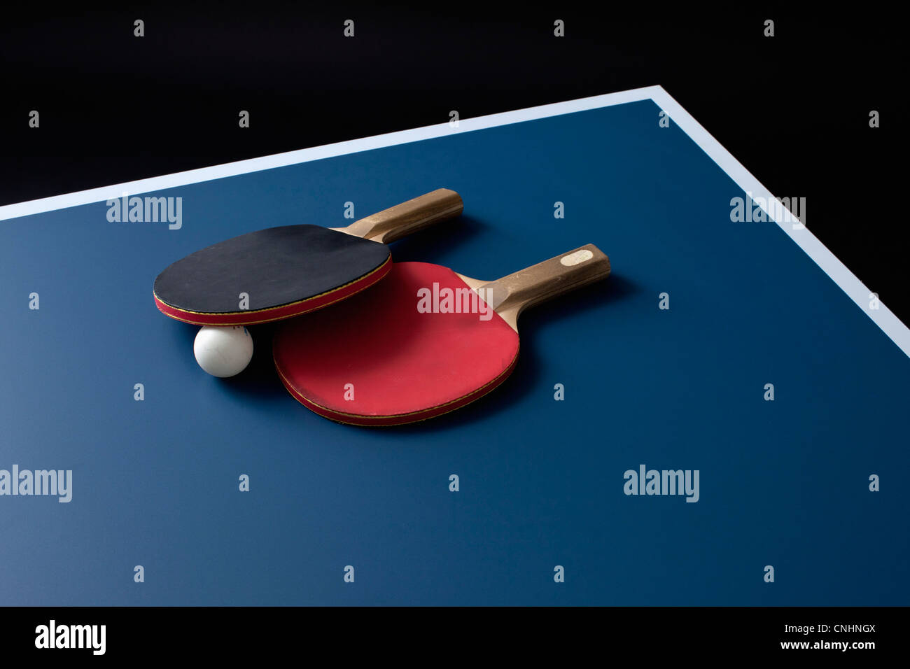 Tischtennisschläger und einen Ball auf einem Tisch Stockfoto