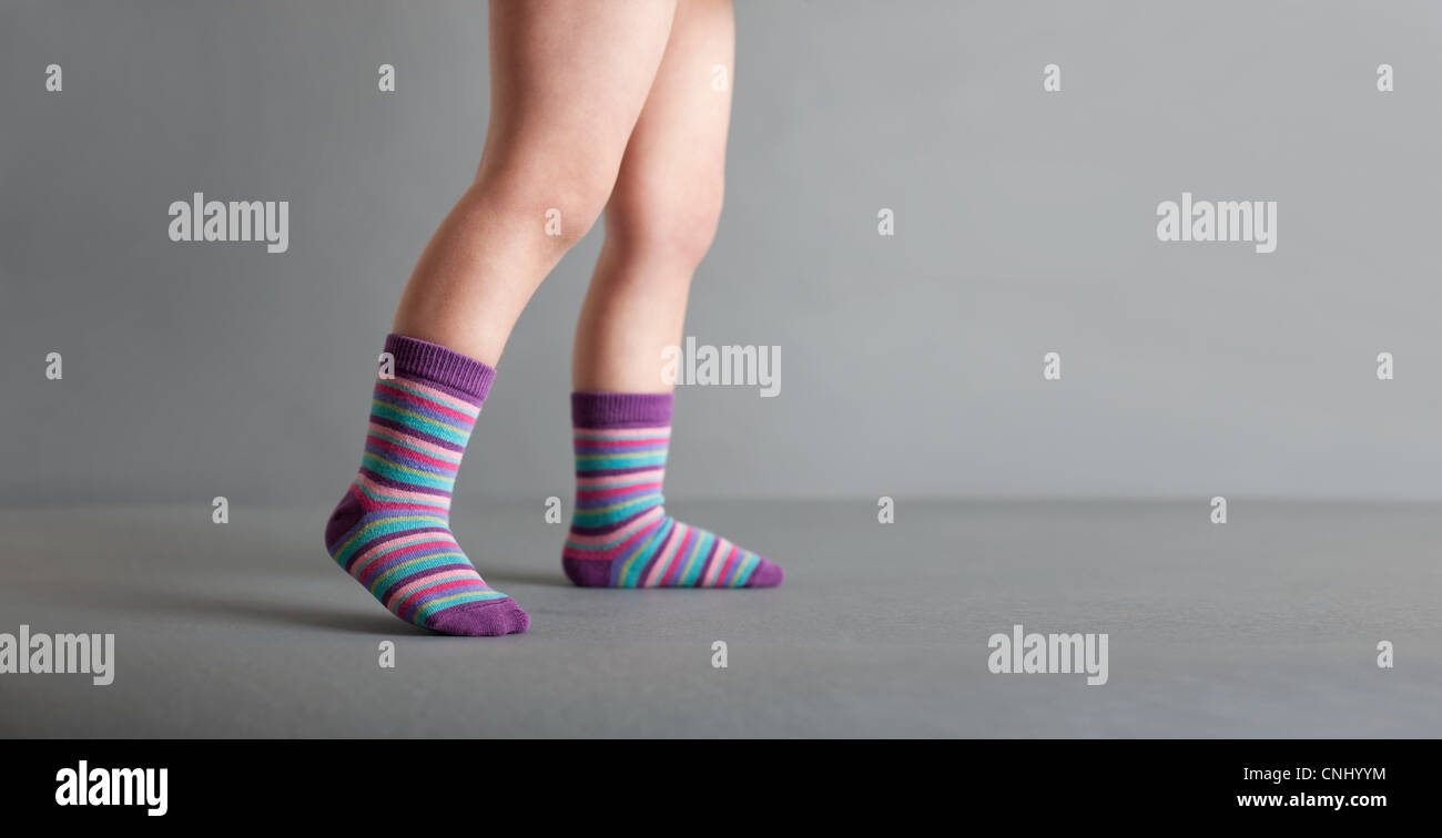 Kind trägt gestreifte Socken Stockfoto