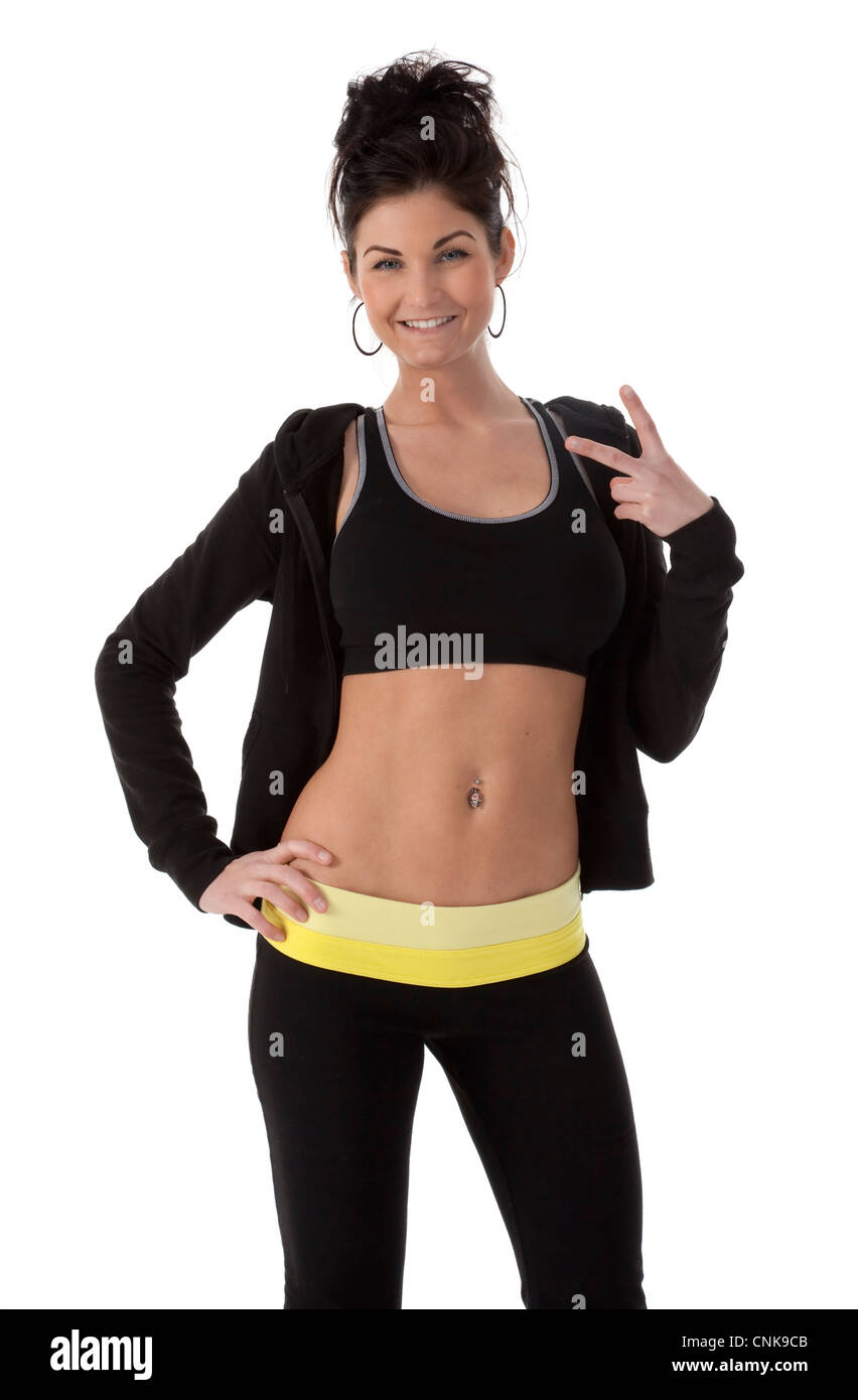 Hübsche junge Erwachsene Frau im Fitness Kleidung auf weißem Hintergrund. Stockfoto
