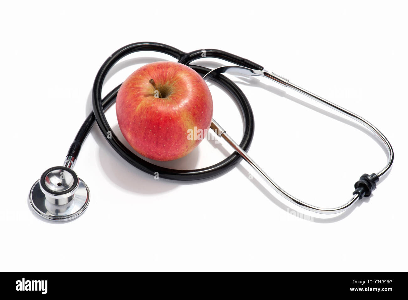 Eine Ärzte-Stethoskop und ein roter Apfel Stockfoto