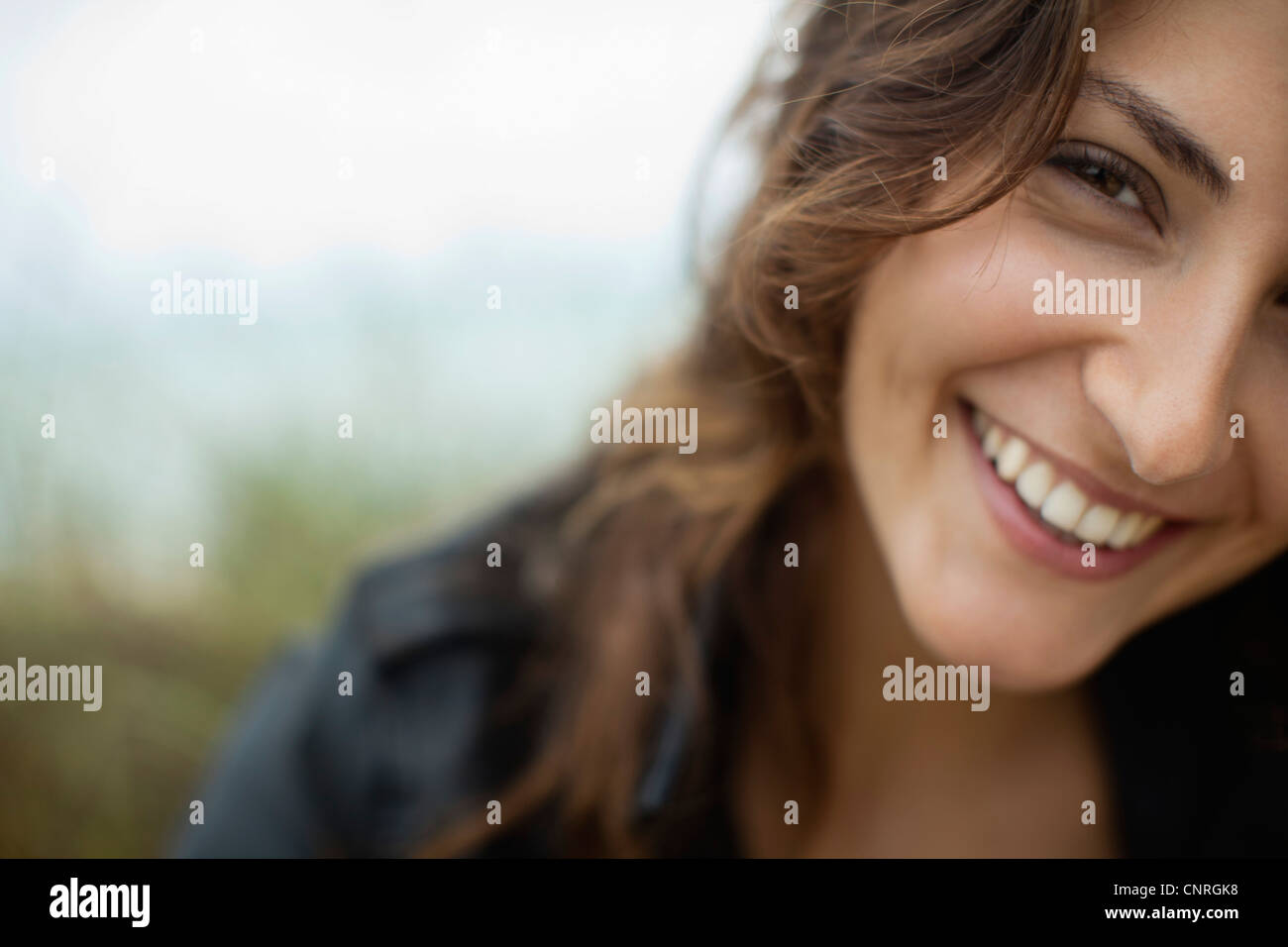 Lächelnde junge Frau, beschnitten Stockfoto