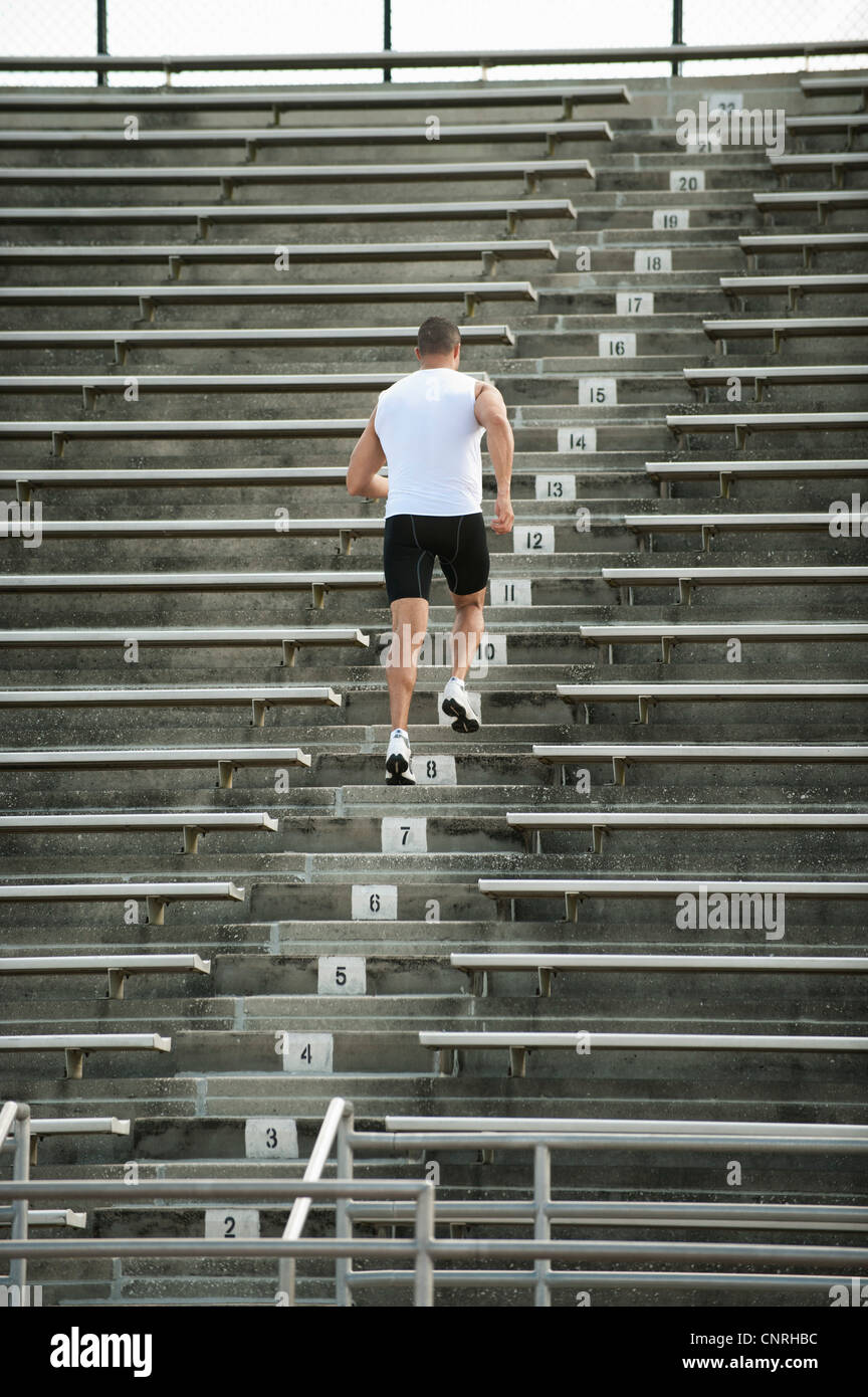 Mann läuft Treppen im Stadion, Rückansicht Stockfoto