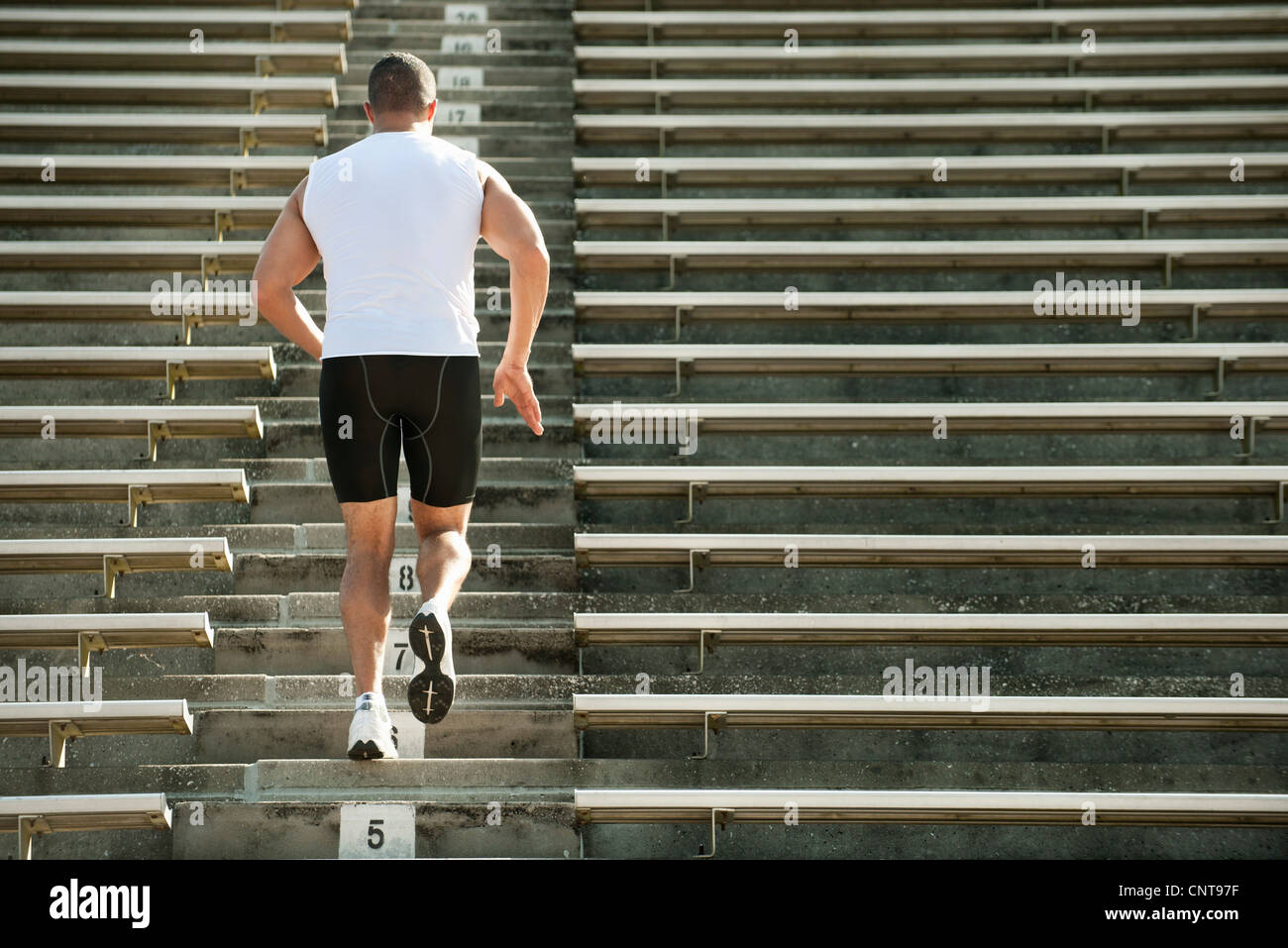 Mann läuft Treppen im Stadion, Rückansicht Stockfoto