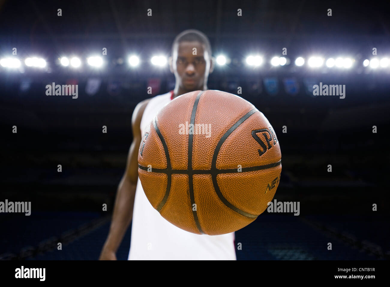 Basketball-Spieler Basketball, Fokus auf Vordergrund halten Stockfoto