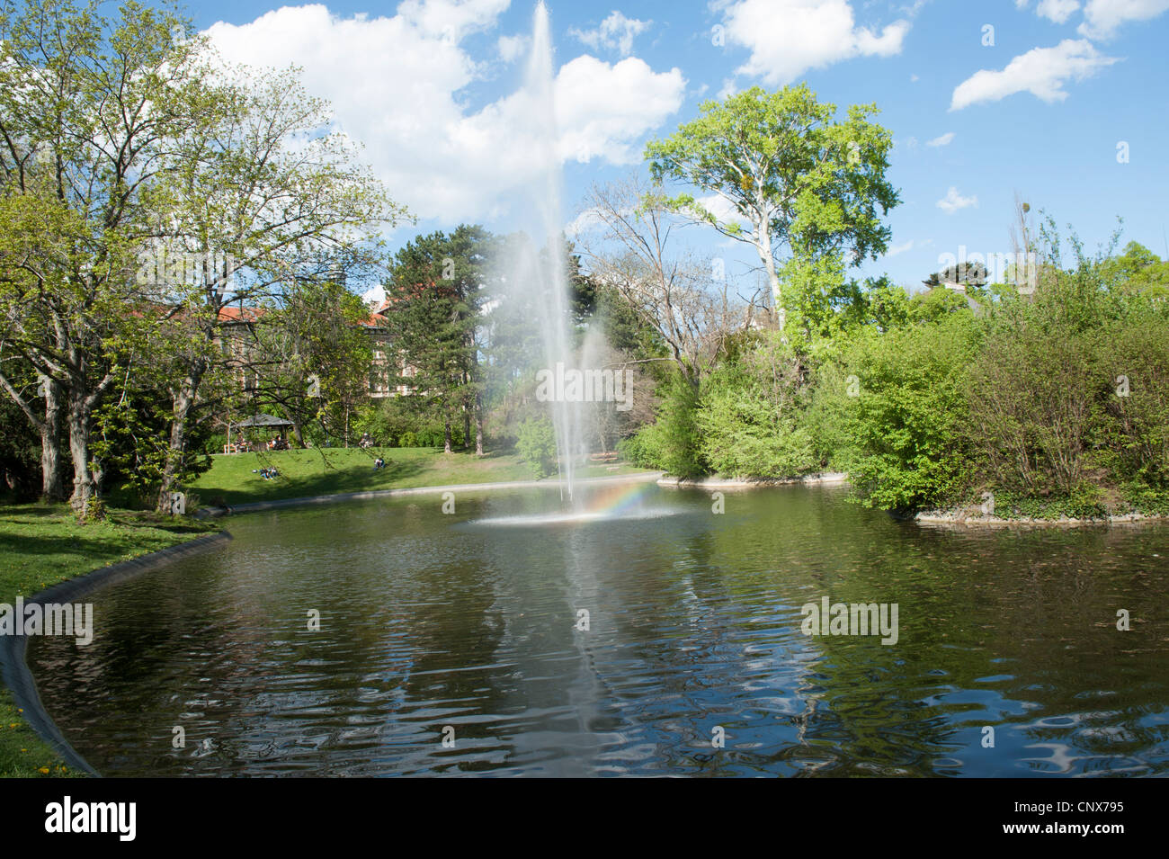 Teich mit Springbrunnen im Türkenschanzpark und Häuser im Hintergrund