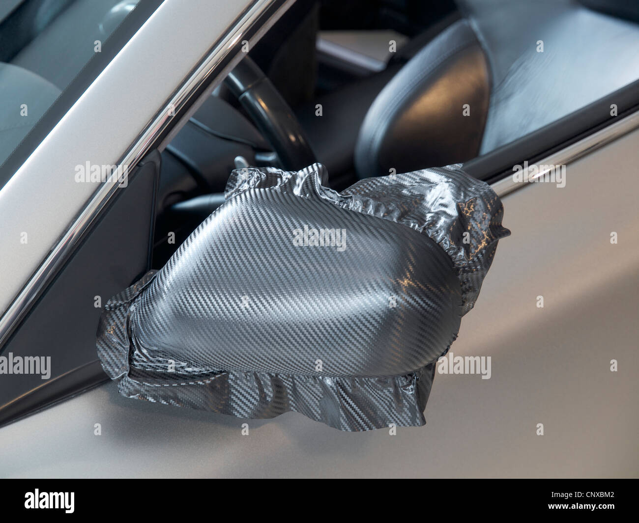Seitenspiegel von Aston Martin Sportwagen mit Carbonlook Folie gewickelt wird Stockfoto