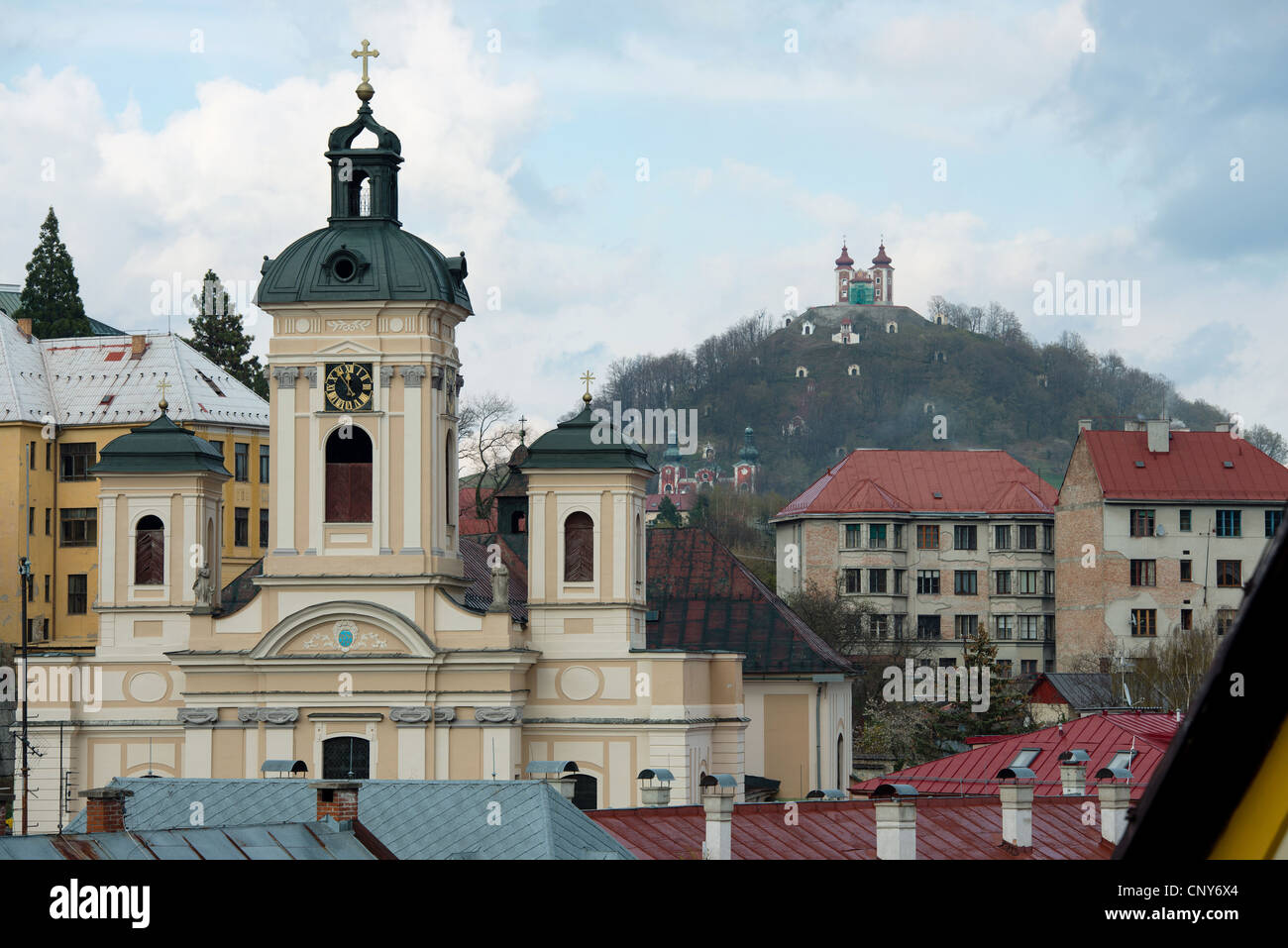 Pfarrkirche in Banska Stiavnica mit Kalvarienberg im Hintergrund, Slowakei Stockfoto