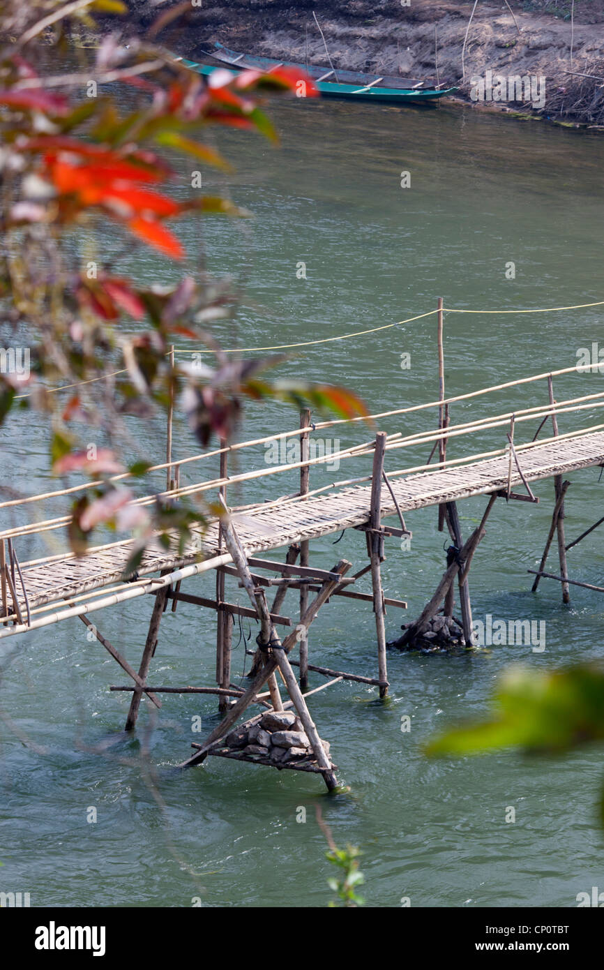 Eine fadenscheinige Bambus Fußgängerbrücke Passerelle de Bambous über Khan River, einem Nebenfluss des Mekong (Luang Prabang - Laos) geworfen. Stockfoto