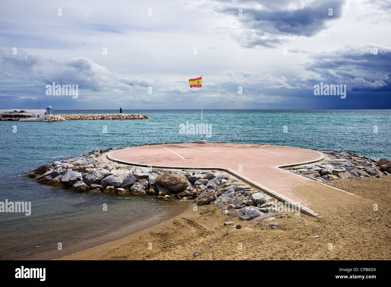 Hubschrauberlandeplatz am Mittelmeer mit spanischen Flagge in Marbella, Costa Del Sol, Provinz Malaga, Spanien. Stockfoto