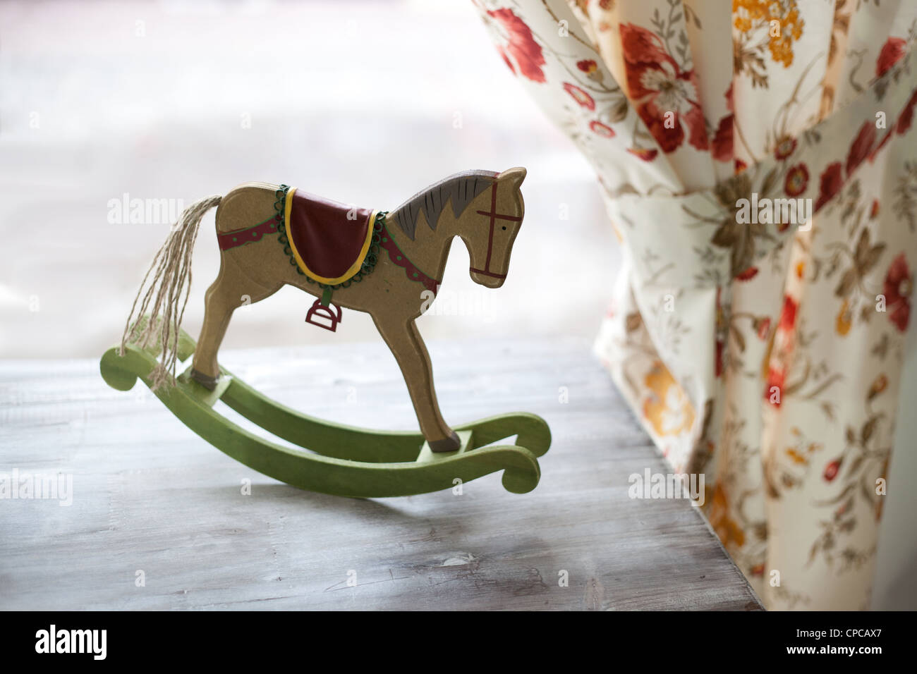 Pferd-Spielzeug auf Vintage-Hintergrund mit curtaine Stockfoto