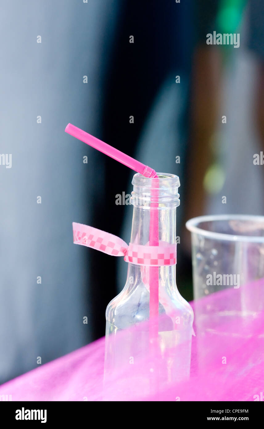Nahaufnahme von Pop-Trinkflasche mit Stroh und Glas Stockfoto