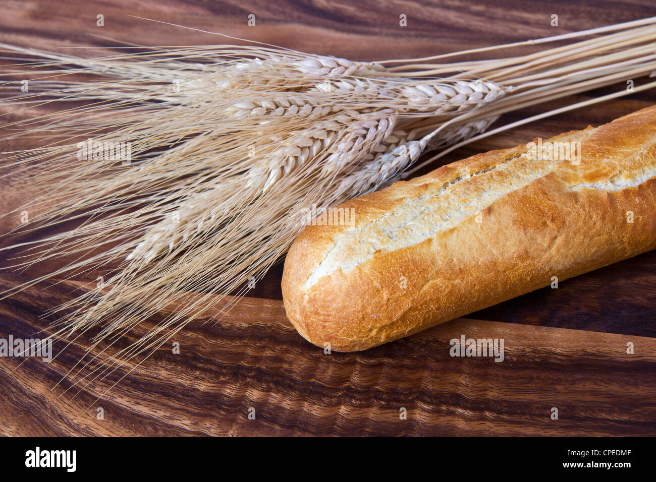 Frisches Brot mit Weizen Stengel auf Schwarze Walnuss board Stockfoto