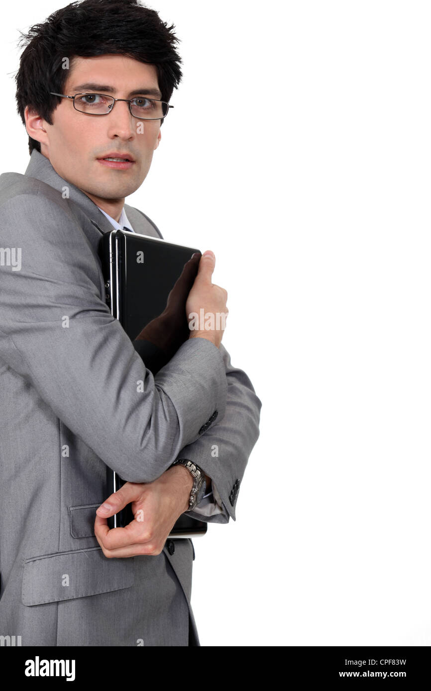Geschäftsmann, umklammert seinen laptop Stockfoto