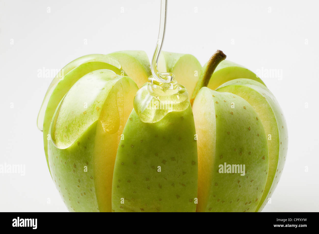 Honig auf Apfel Stockfoto