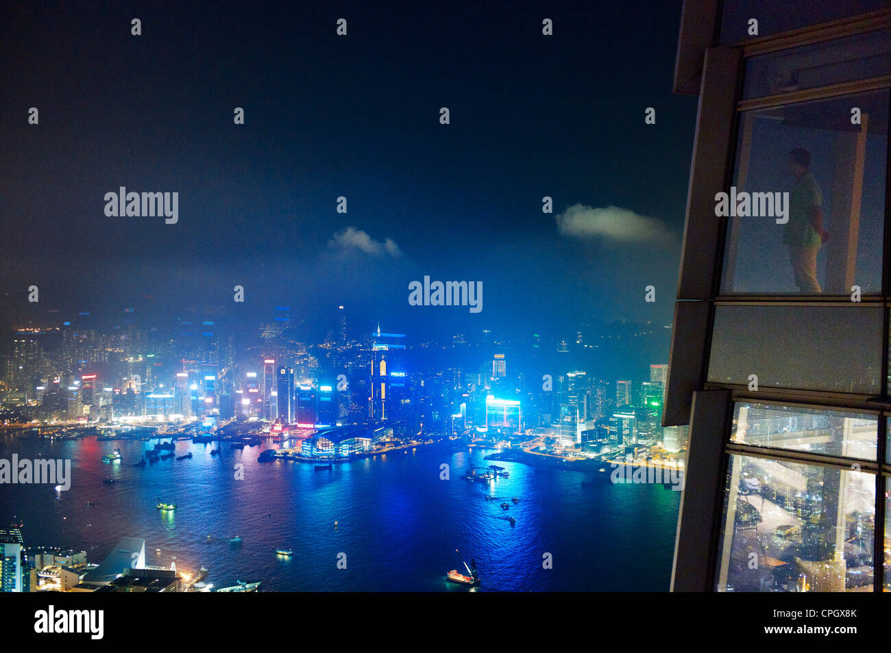 Ein Mann blickt im Central Hong Kong in der Nacht vom International Commerce Centre Stockfoto