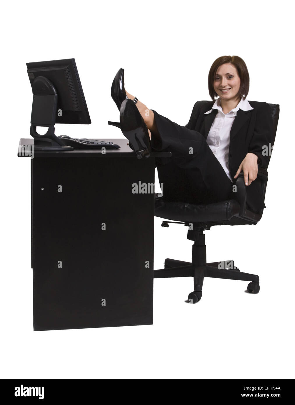 Entspannte Geschäftsfrau an ihrem Schreibtisch. Stockfoto