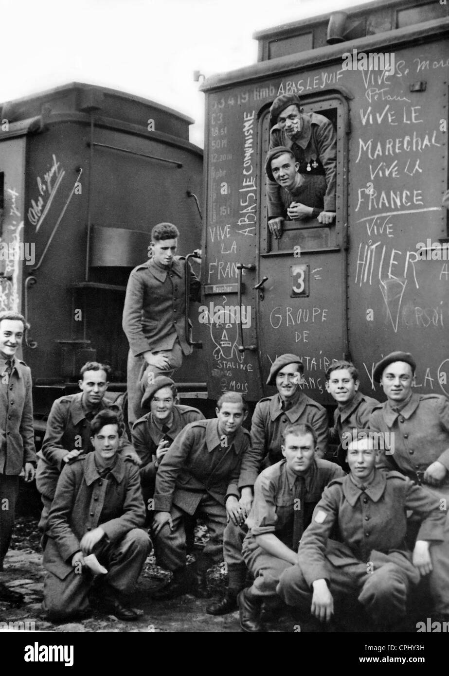 Mitglieder der Legion des französischen Freiwilligen stellen neben ihren Eisenbahnwaggon, die mit anti-Semitic und Anti-kommunistischen gemalt Stockfoto