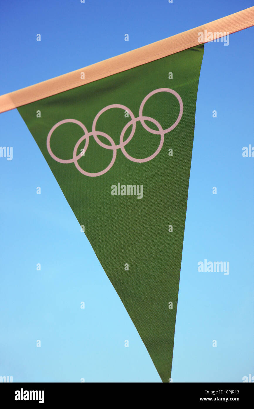 Olympische Ringe auf eine grüne Bunting Flagge vor einem blauen Himmel - nur zur redaktionellen Nutzung Stockfoto
