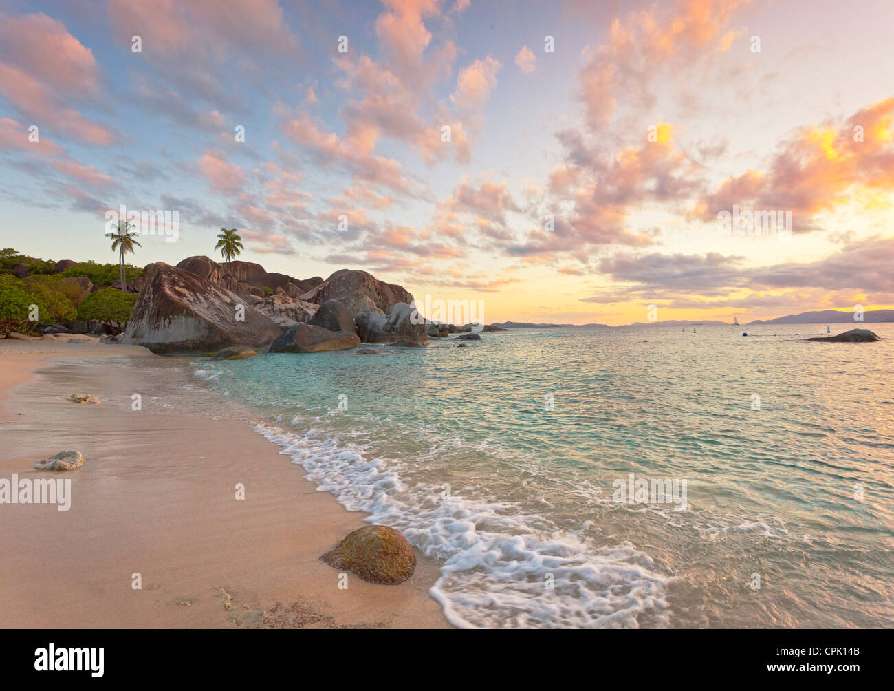 Virgin Gorda, Britische Jungferninseln, Karibik Wellen Waschen der sandigen Küste der Bäder Nationalpark bei Sonnenuntergang. Stockfoto