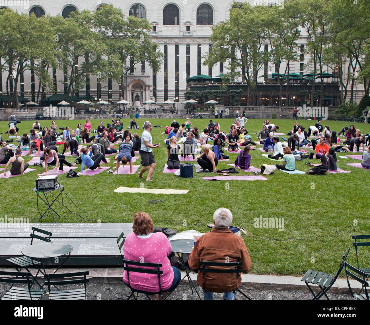 Ein Outdoor-Klasse Yogaübungen im Bryant Park in New York City. Stockfoto