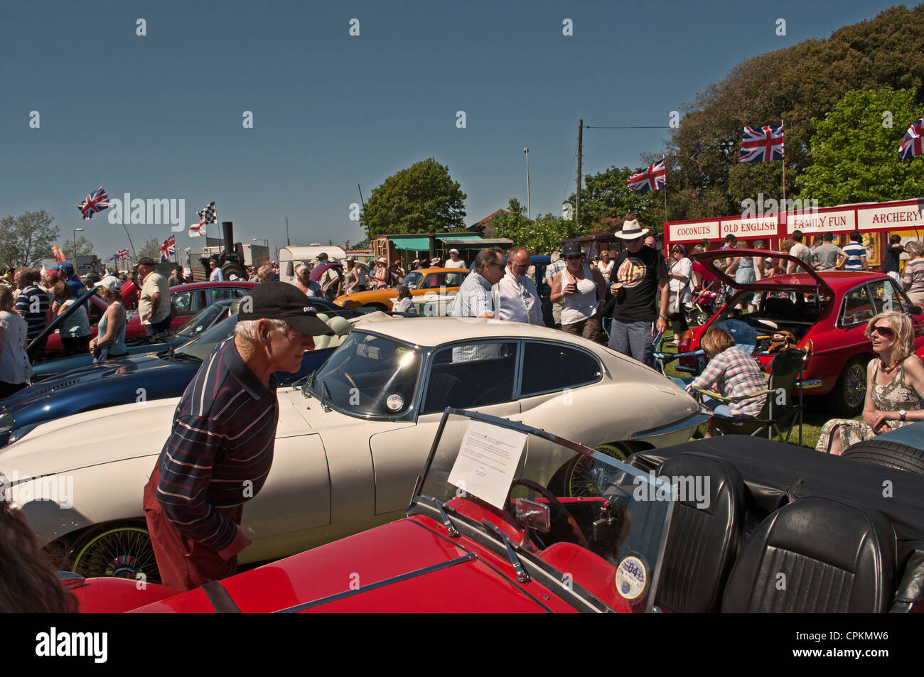 Mann Lesen der Informationen auf Riley roadster Frontscheibe Classic Car Show, E-type Jaguar sichtbar, Yarmouth alte Oberbeleuchter Festival, I-o-W, Stockfoto