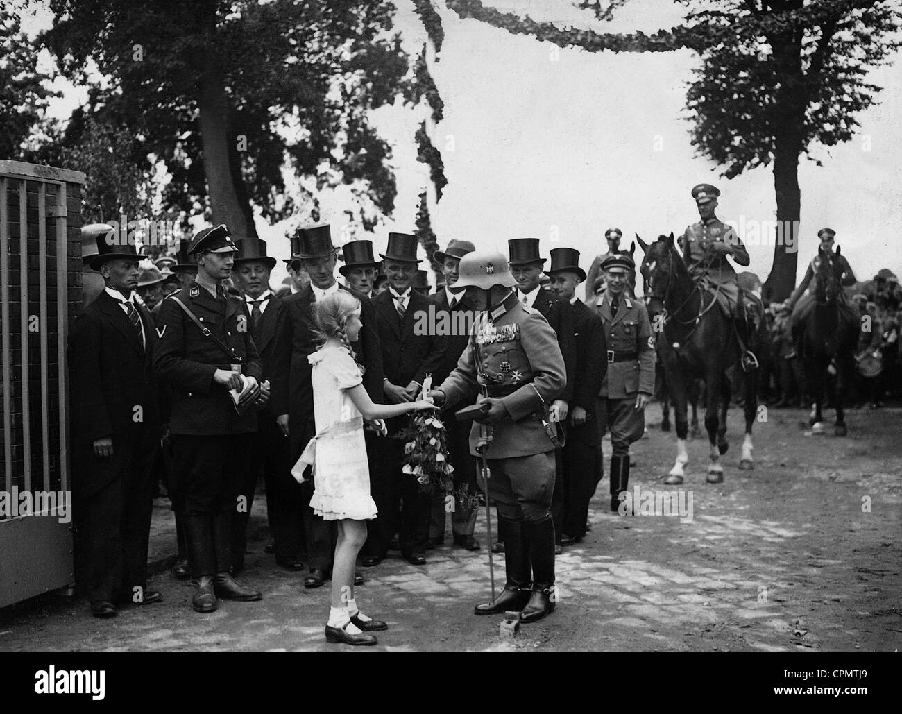 Mädchen gibt Regiments Kommandeur Graf Sponeck einen Blumenstrauß Stockfoto