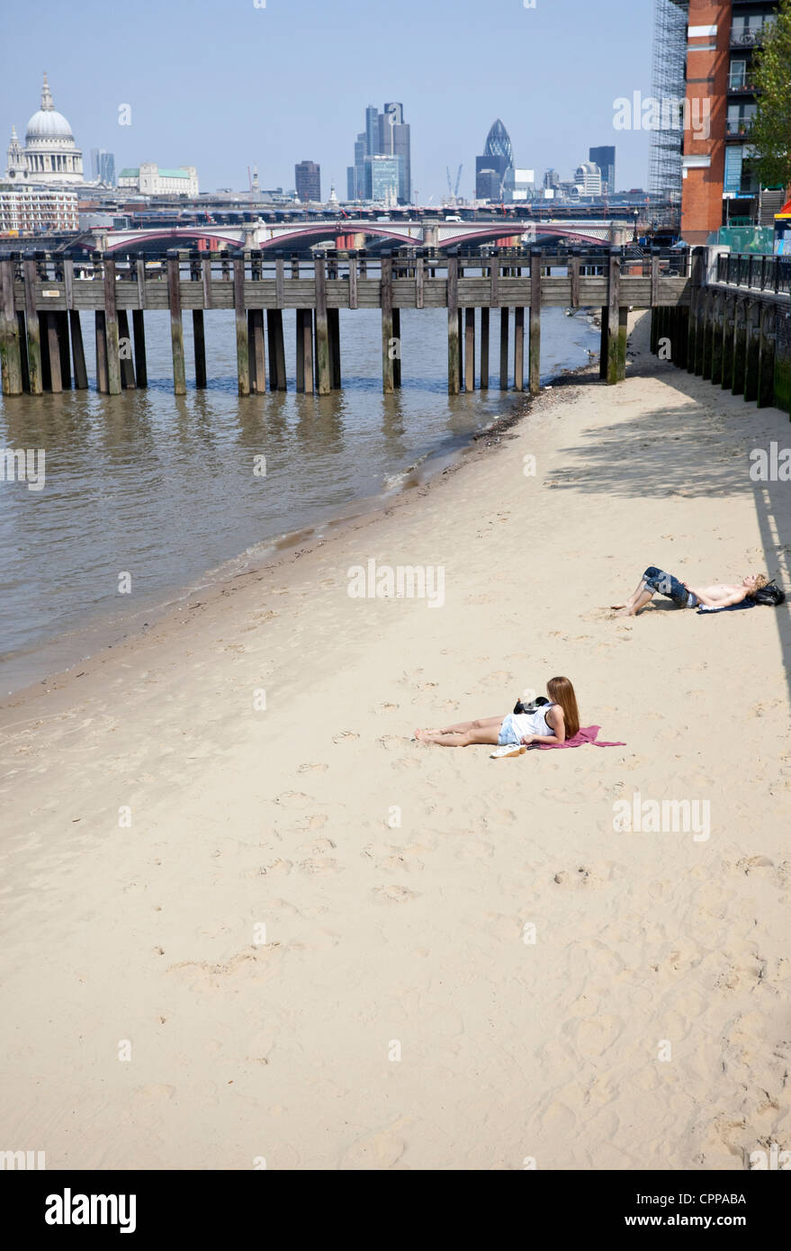 Sonnenbaden am Sandstrand von Themse, Southbank, London, England, UK Stockfoto