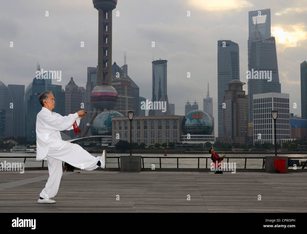 Tai Chi Schwert Master und Kite Flyer auf den Bund mit Pudong Hochhaus ragt am Morgen Shanghai Peoples Republic Of China Stockfoto