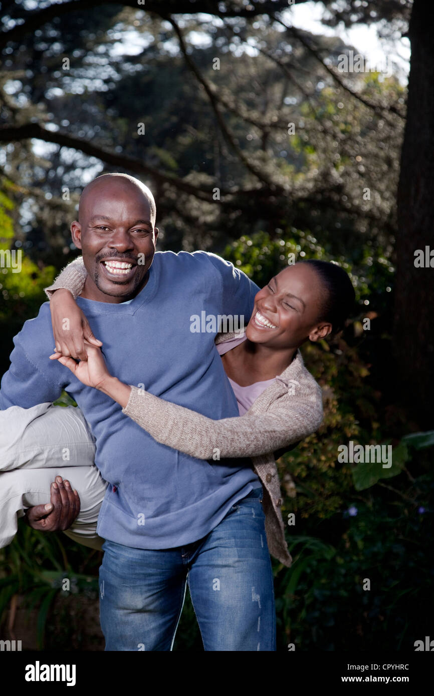 Ein Mann trägt spielerisch seine Frau, Illovo Familie, Johannesburg, Südafrika. Stockfoto