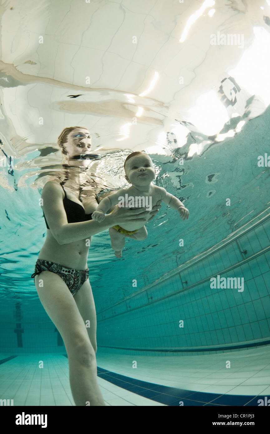 Frau, Baby, im Pool schwimmen lehren Stockfoto