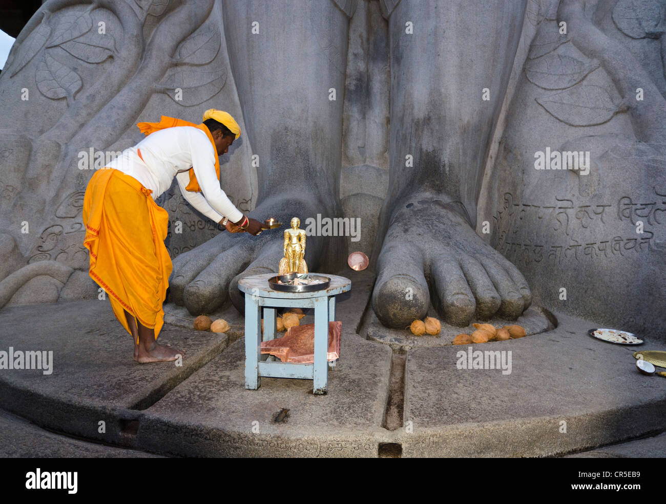 Ortspfarrer seine Gebete vor der Statue von Lord Gomateshwara, der höchste monolithische Statue in der Welt zu tun, Stockfoto