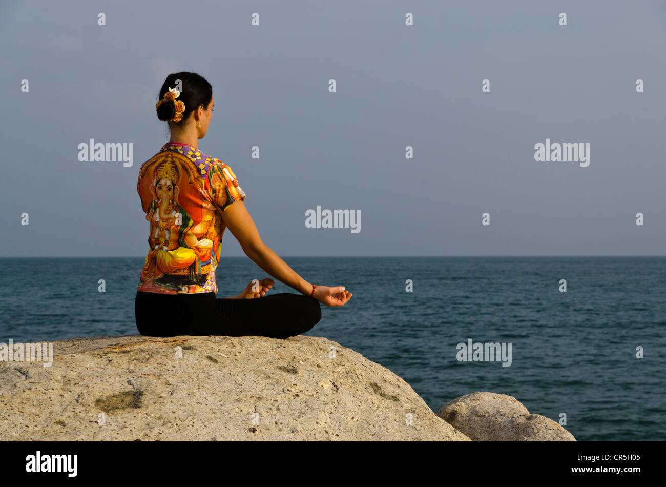 Frau in einem Yoga-position, Padmasana, direkt am Meer in Kanyakumari, Tamil Nadu, Indien, Asien Stockfoto