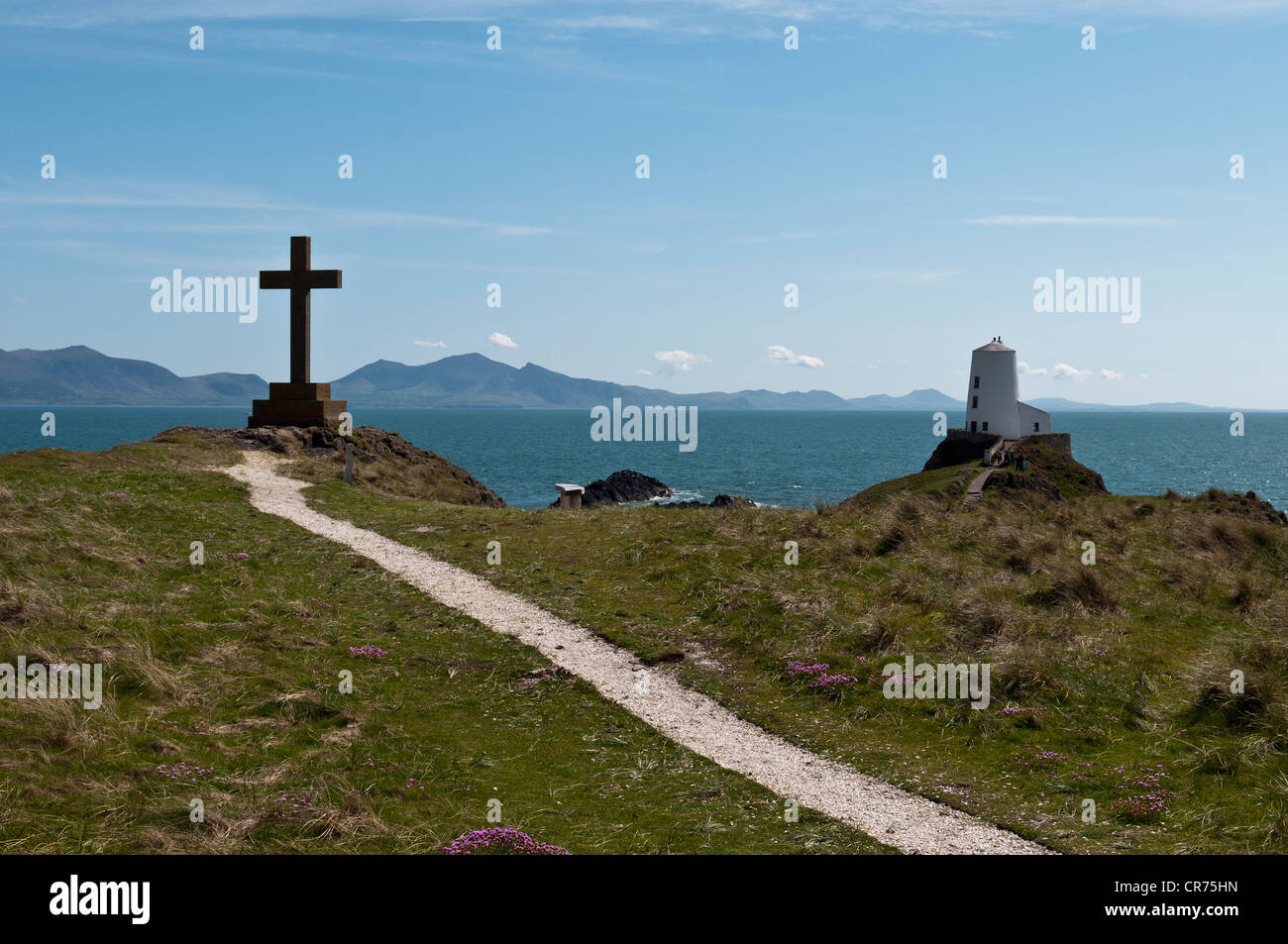 Großes Kreuz mit Blick auf den alten Leuchtturm und Lleyn-Halbinsel auf Llanddwyn Insel Anglesey North Wales Stockfoto