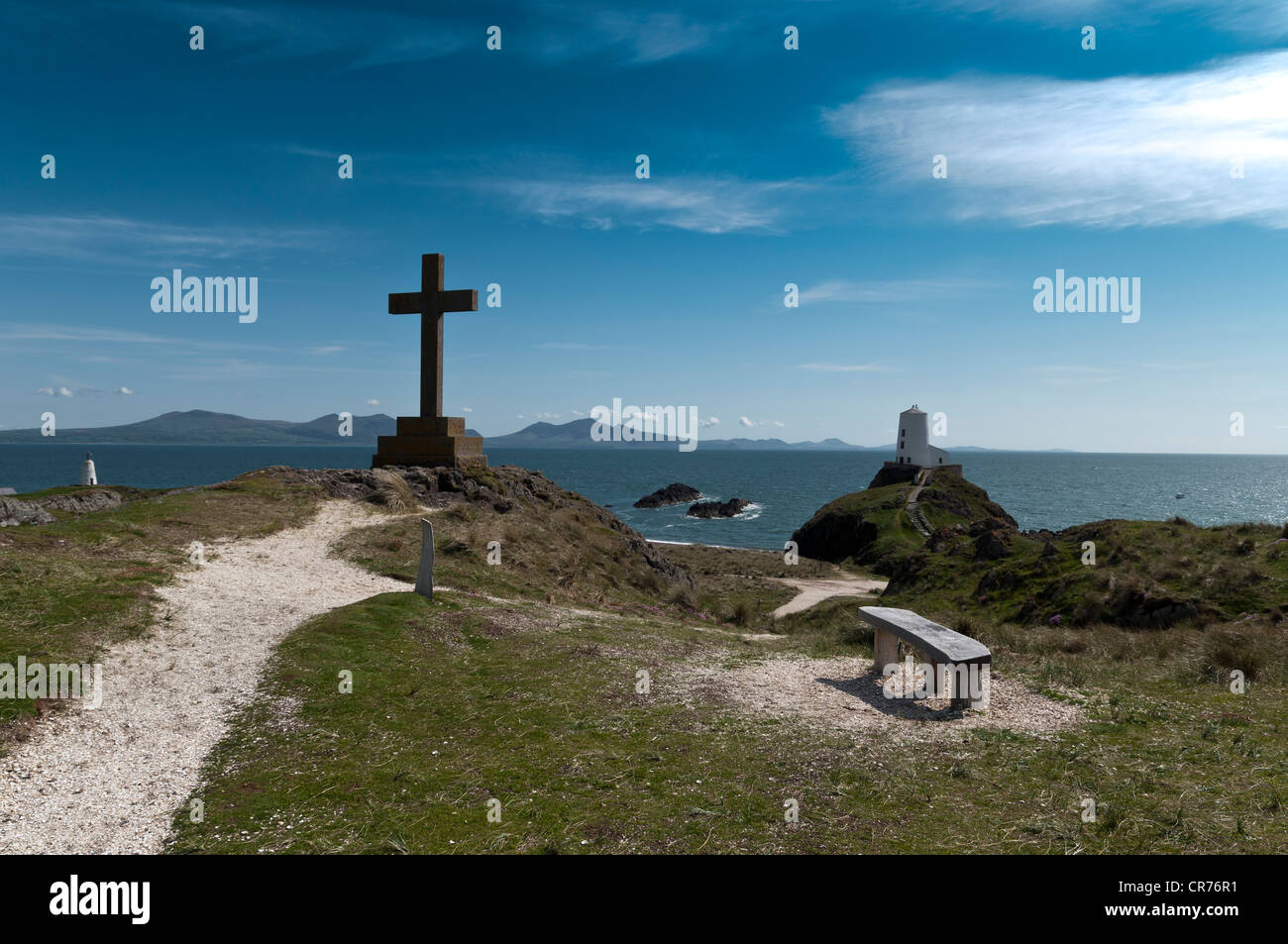 Geschnitzte Holzsitz mit Blick auf den alten Leuchtturm und Lleyn-Halbinsel auf Llanddwyn Insel Anglesey North Wales Stockfoto